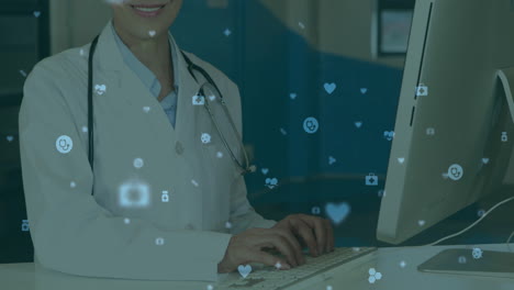 typing on keyboard, doctor surrounded by floating animation of social media icons