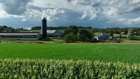 Aerial-truck-shot-of-family-farm-with-barn-and-silo