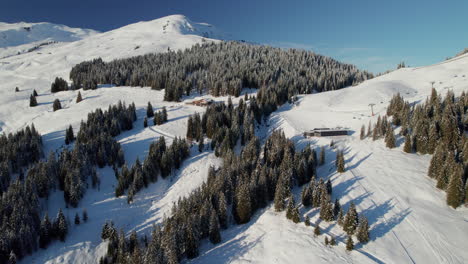 Fly-Over-Forest-And-Slope-Mountains-Mountains-Near-Saalbach-Hinterglemm-Alpine-Resort-Town-In-Austria