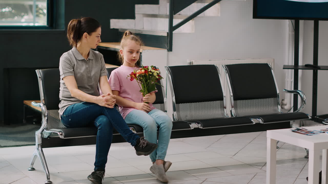 Mother and young child waiting in hospital reception