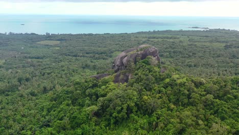 aerial of batu baginda boulder on a cloudy