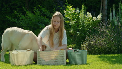 girl doing laundry outdoors with dog
