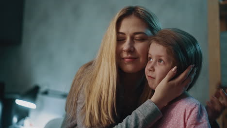 Woman-with-little-daughter-hugs-spending-time-at-home