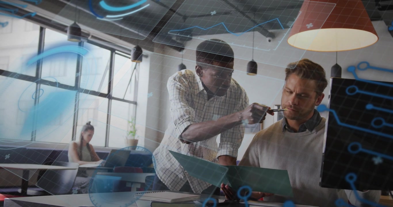 Colleagues leaning over blueprint, pointing pen, revealing holographic chart for tech design review
