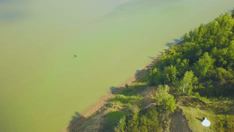 round view from couple on riverbank to distant town