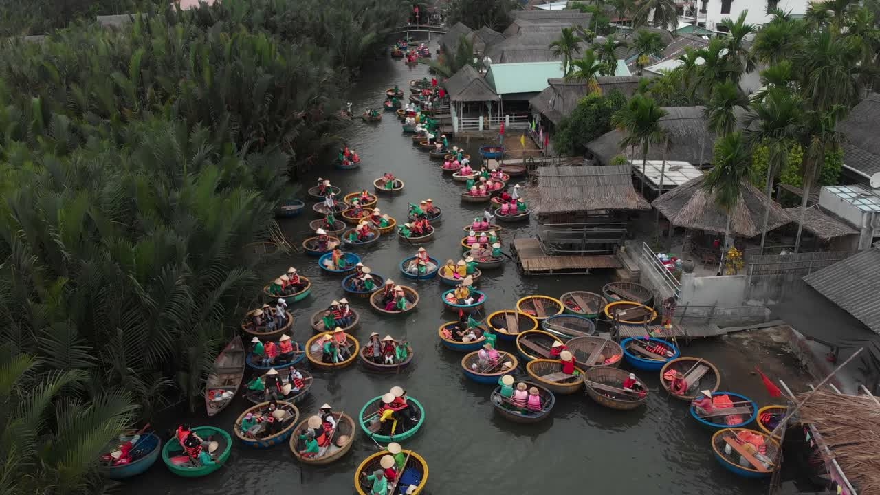 Pemandangan udara perahu keranjang tradisional di sungai yang tenang dikelilingi pohon kelapa di Cam Thanh, Hoi An, Quang Nam, Vietnam