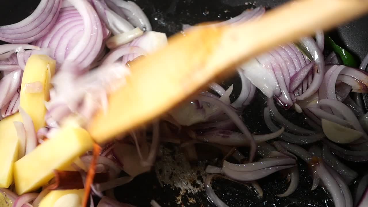 Cooking with onions, potatoes, and spices