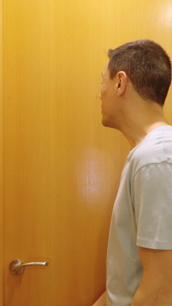 Impatient man waiting for the toilet to become available