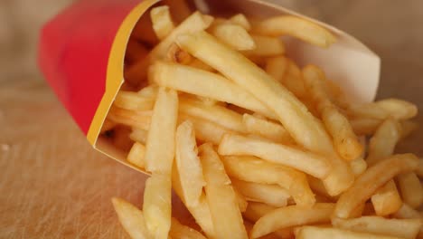 portion of unhealthy food, fast food, paper bag with fries rotating, turning