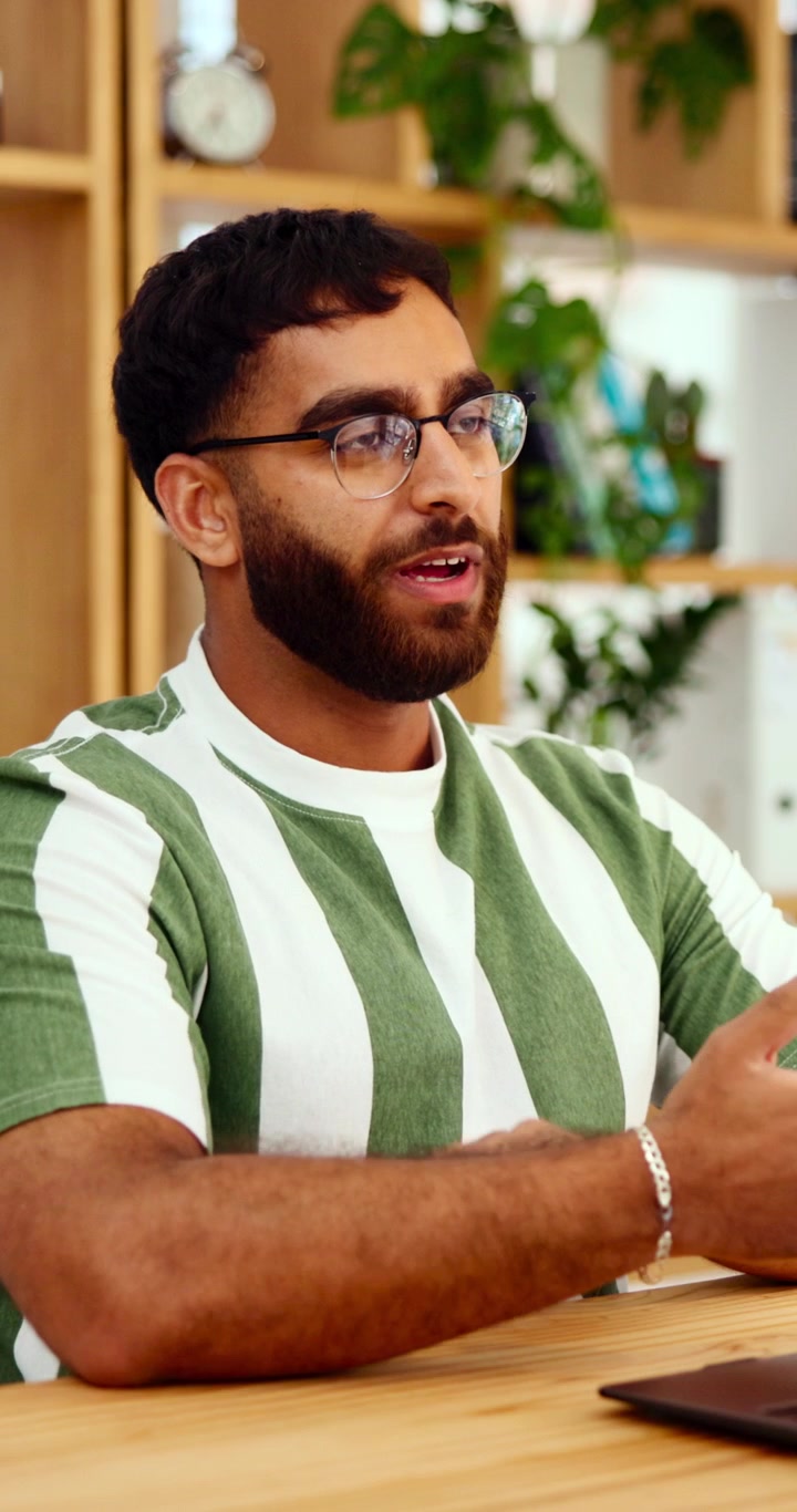 Young Man Talking and Gesturing During a Professional Meeting