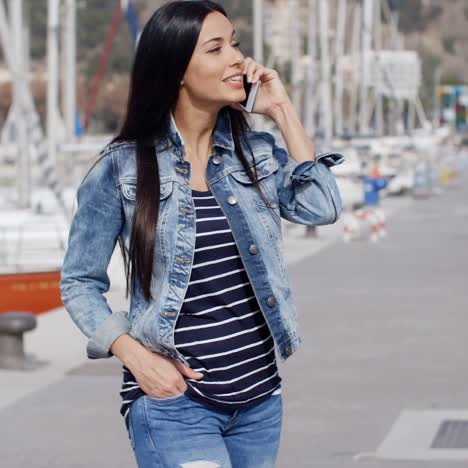 trendy relaxed young woman talking on a mobile