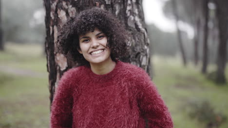 charismatic young mixed race black girl blowing her curls in winter