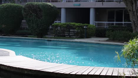calm swimming pool by residential buildings