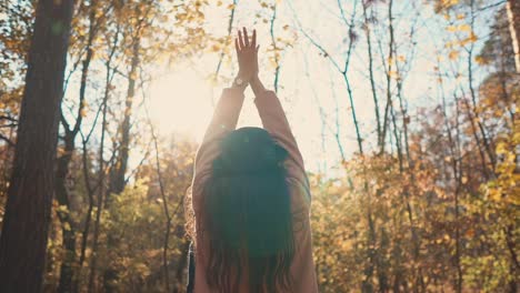 woman enjoying autumn in the forest