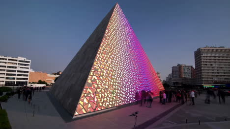 pyramid with light show in cityscape