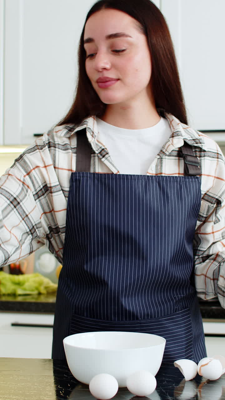 Young woman cracking eggs in kitchen bowl preparing simple breakfast omelet or baking dough at home