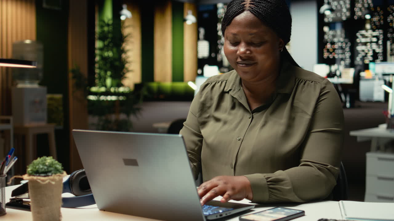 African american woman experiences weariness and checks her phone for a break