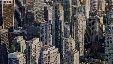 vancouver bc canada aerial v46 cinematic zoomed birds eye view flyover the concrete jungle of downtown area capturing urban cityscape with towering skyscrapers - shot with mavic 3 pro cine - july 2023