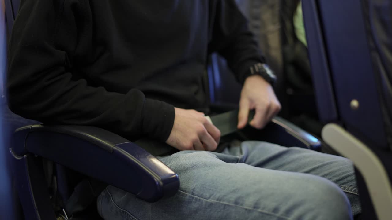 Close up view of man's hands fastening himself on plane