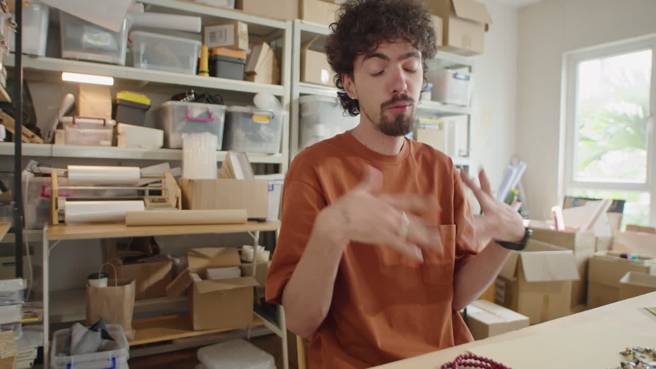 Male Blogger Showing DIY Jewelry and Talking on Camera