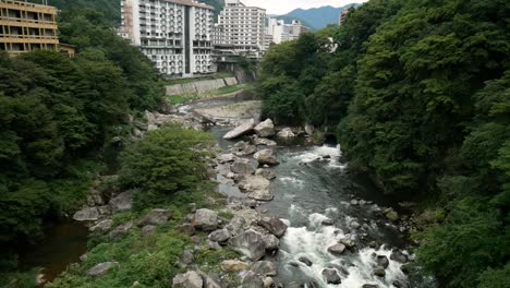 small creek flowing close to an urban cityscape