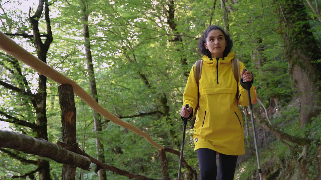 Woman Hiking in Forest with Trekking Poles
