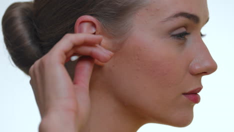 Portrait-of-a-woman-in-the-studio-using-an-ecological-ear-cleaning-cotton-stick-made-from-paper