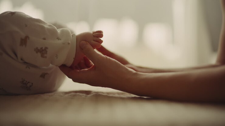 Mother Playing with Newborn's Tiny Feet