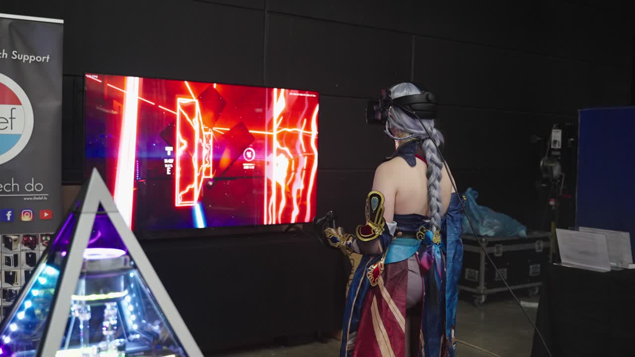 Girl in a cosplay costume wearing VR goggle playing a game where she has to hit objects with a saber controlled with her hands at convention event LGX in Luxembourg