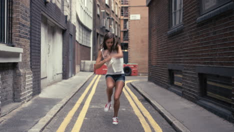 Contemporary-funky-caucasian-woman-street-dancer-dancing-freestyle-in-the-city