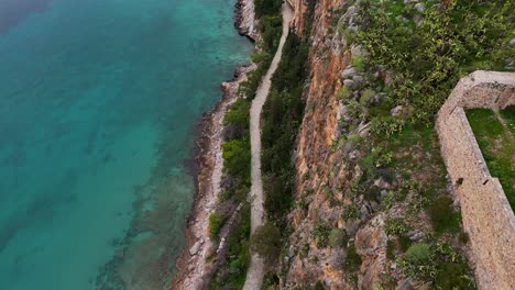 Aerial-View-Over-Arvanitia-Walking-Area-Coastal-Shoreline,-Peloponnese-Region,-Greece