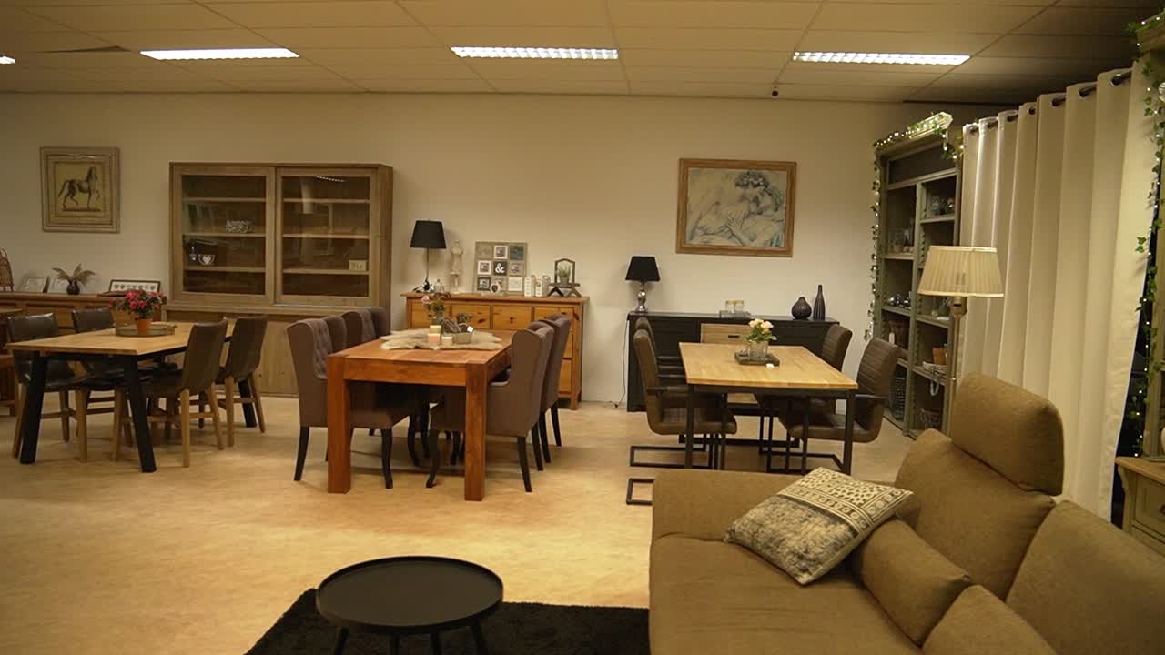 Interior view of a furniture showroom with various setups