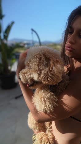 young woman holds a fluffy poodle