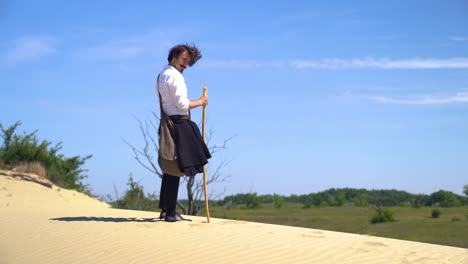 Hungarian-poet-Sandor-Petofi-surveys-surroundings-from-atop-sand-dune