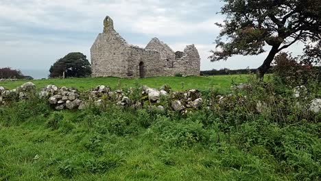 the ruins of capel lligwy in peaceful moelfre countryside, anglesey, north wales