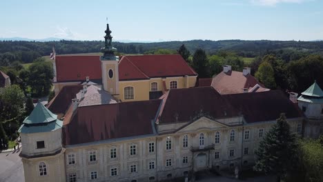 drone is flying over by a church tower from above