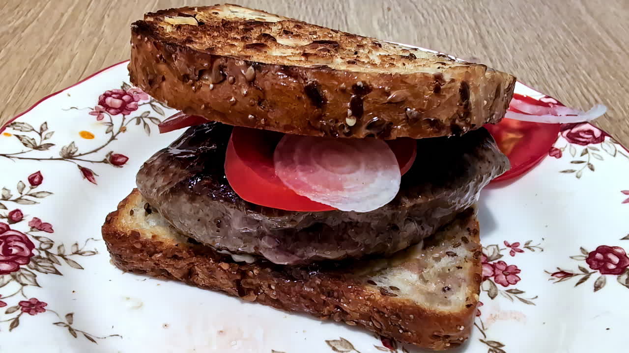 Toasted sandwich with beef, onion, and tomato. Homemade fast food