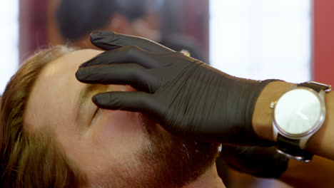 man getting his beard shaved with razor 4k