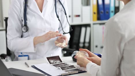 Doctor discussing breast implants with a patient during a consultation