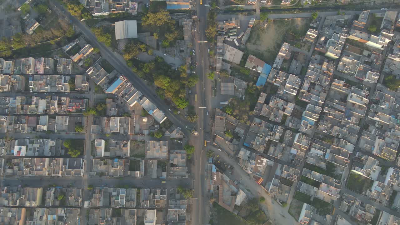 Aerial drone shot displaying a panoramic view of a city, highlighting its intricate road networks, towering buildings, and vibrant city life.