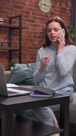 woman talking on phone while working from home