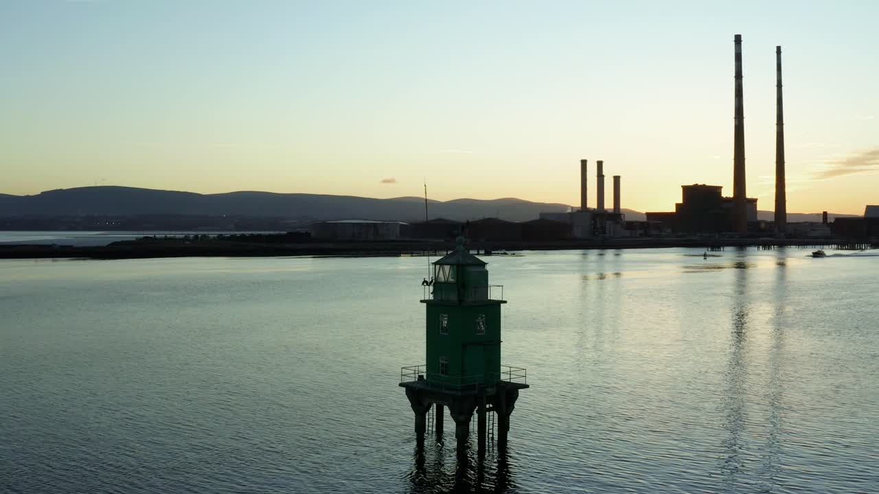 Aerial orbit around lighthouse at Dublin Port, Ireland in the evening