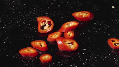 Red Chili Pepper Slices on a Black Surface
