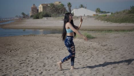 woman taking photos on the beach