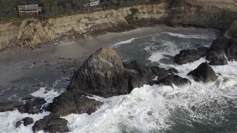 Cinematic-aerial,-waves-crashing-into-rocks-on-North-Pacific-Ocean,-Oregon-coast