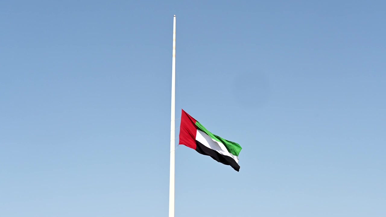 The UAE flag lowered as a symbol of mourning and unity.
