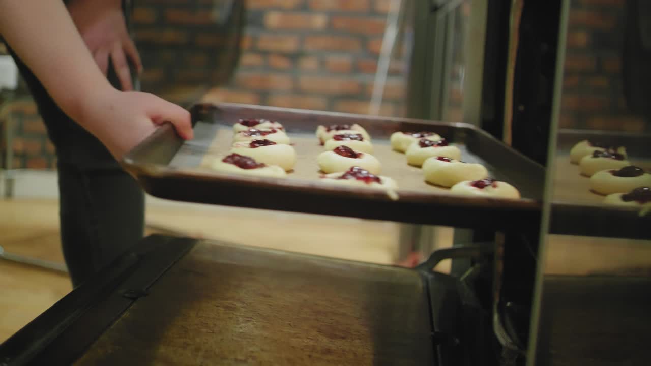 Putting Jam-Filled Sugar Cookies into the Oven