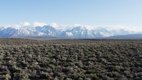 drone flies forward and revealing eastern sierra nevada mountains in california landscape view