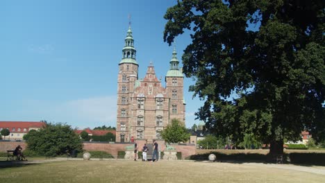 rosenborg slot with a huge tree in the foreground in kongens have, copenhagen, denmark