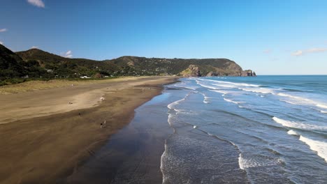 flying down piha beach in new zealand's west coast